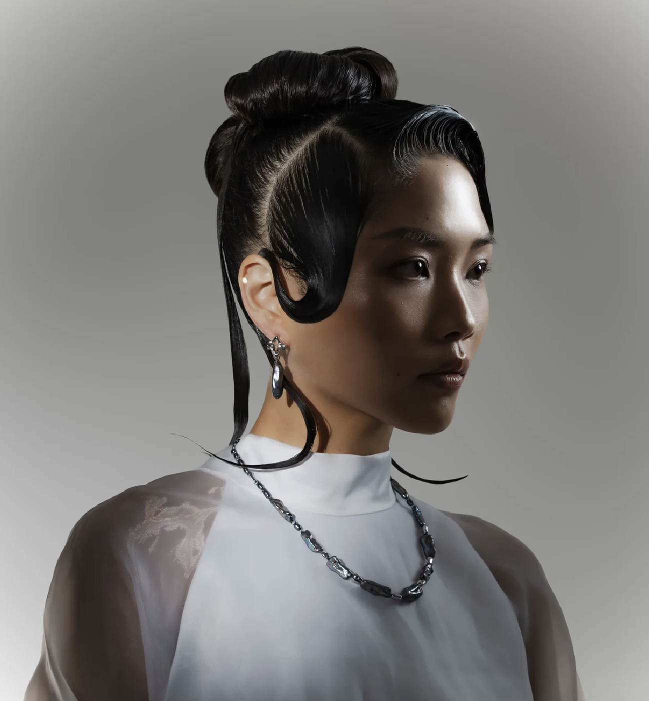 Mayfair Pearls portrait featuring a dark pearl necklace and drop earrings